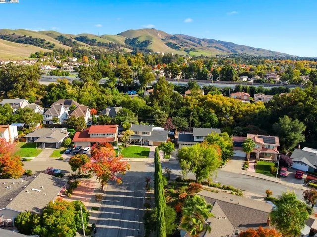 an aerial view of residential houses with outdoor space