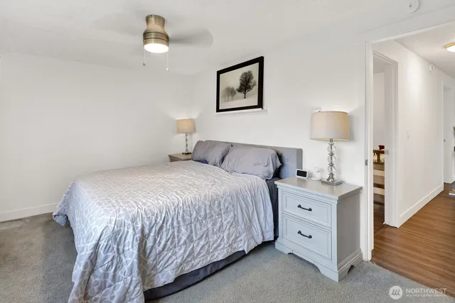 a bedroom with a bed and a night stand