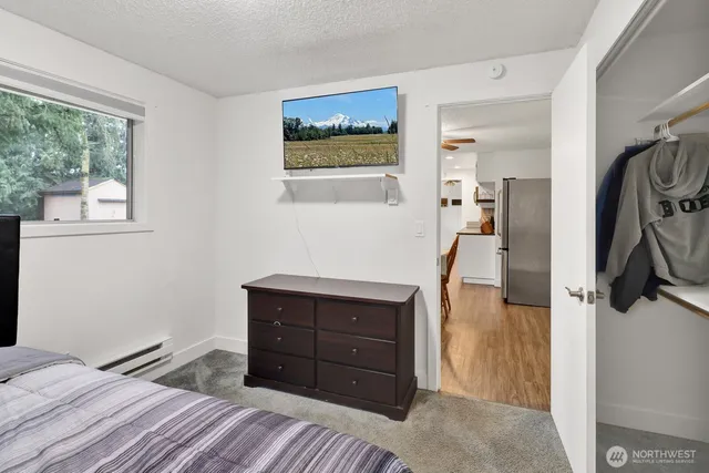 a bedroom with a bed and a dresser