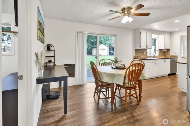 a view of a dining room with furniture and wooden floor