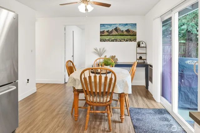 a view of a dining room with furniture and wooden floor