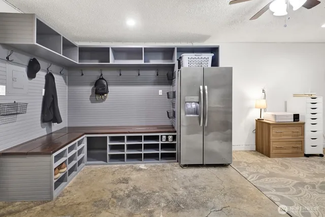 a view of a refrigerator in kitchen and an empty room