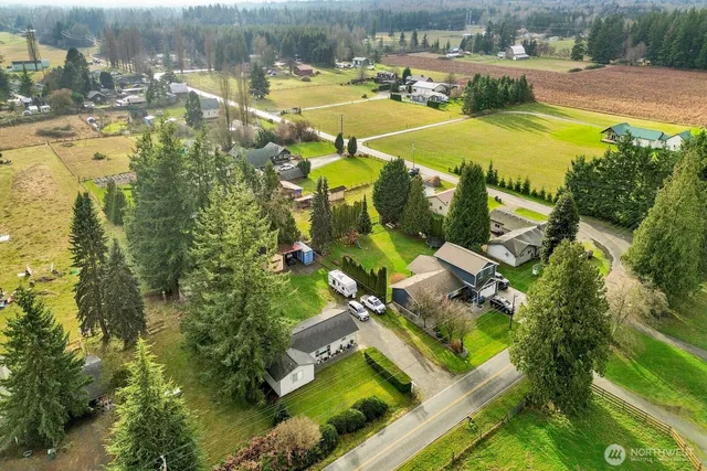 an aerial view of residential houses with outdoor space and swimming pool