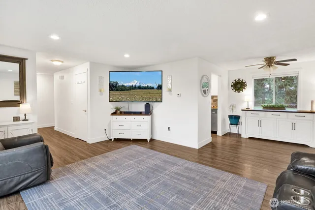 a living room with furniture and view of kitchen