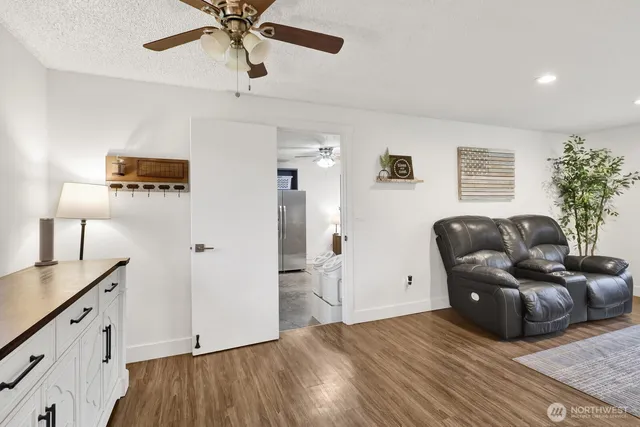 a living room with furniture and a wooden floor