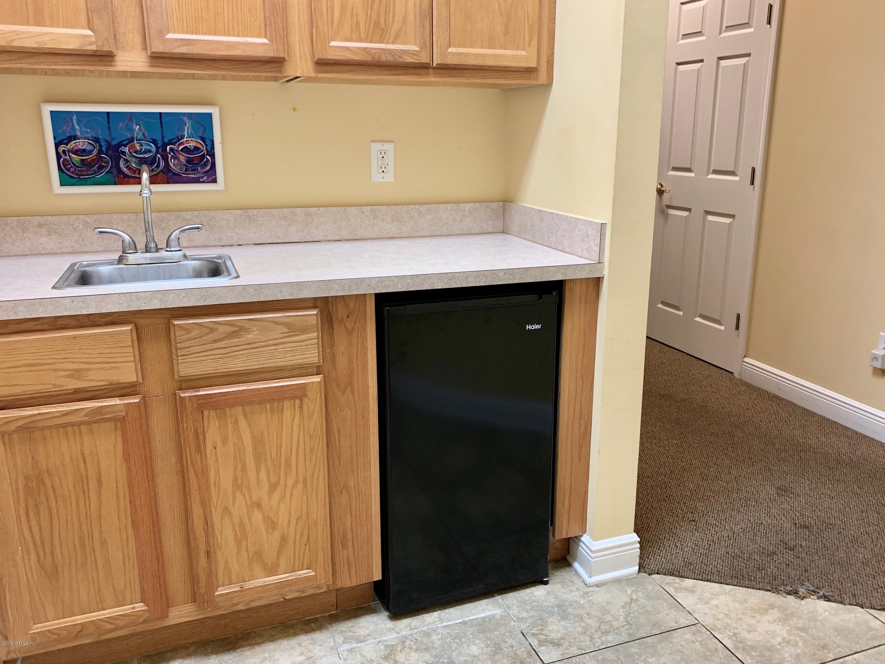 4465 Baymeadows Road, Unit 3 Jacksonville, FL 32217 - Photo 8 of 12 a bathroom with a sink and a mirror