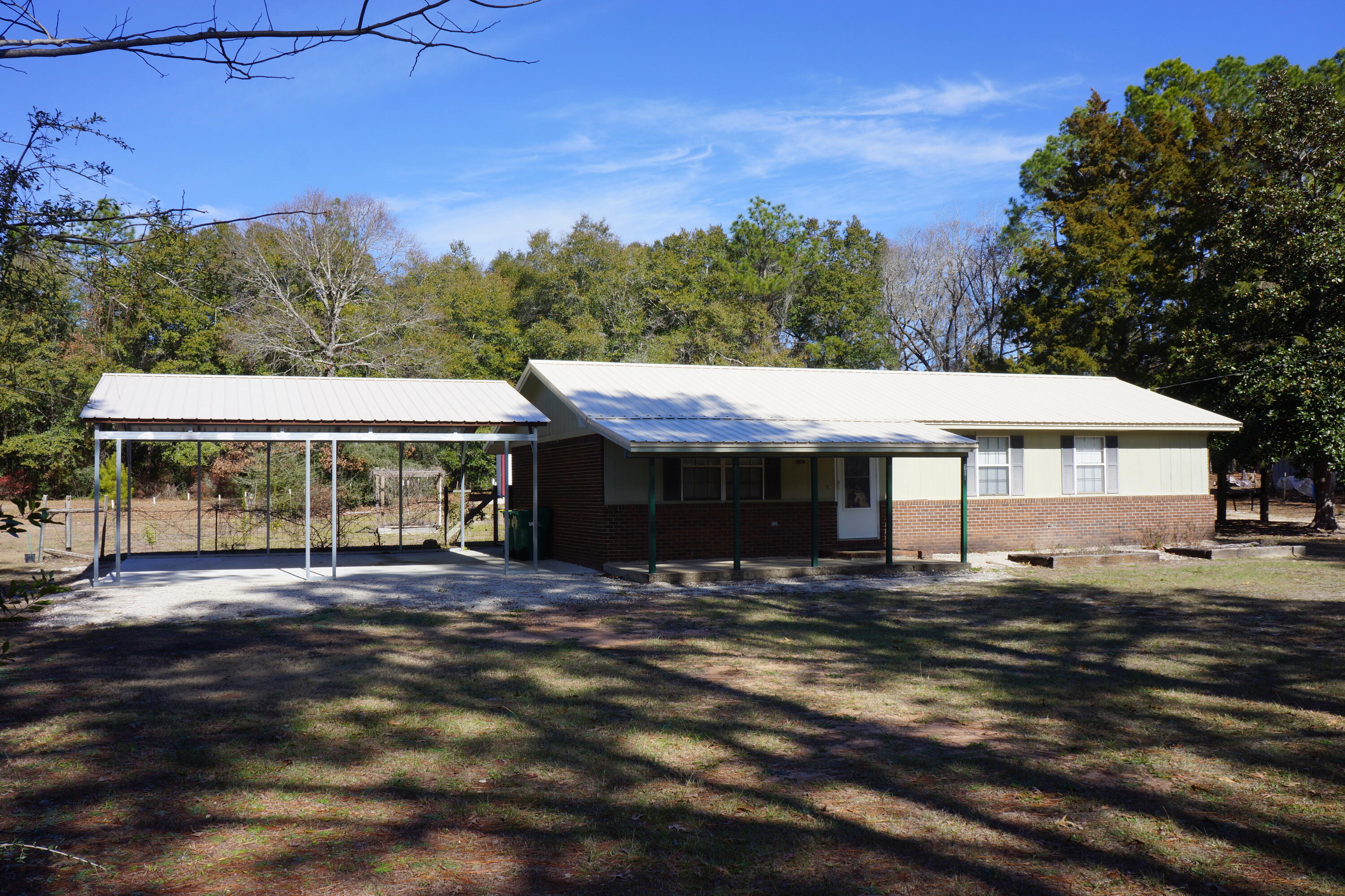 a view of a house with a backyard porch and sitting area