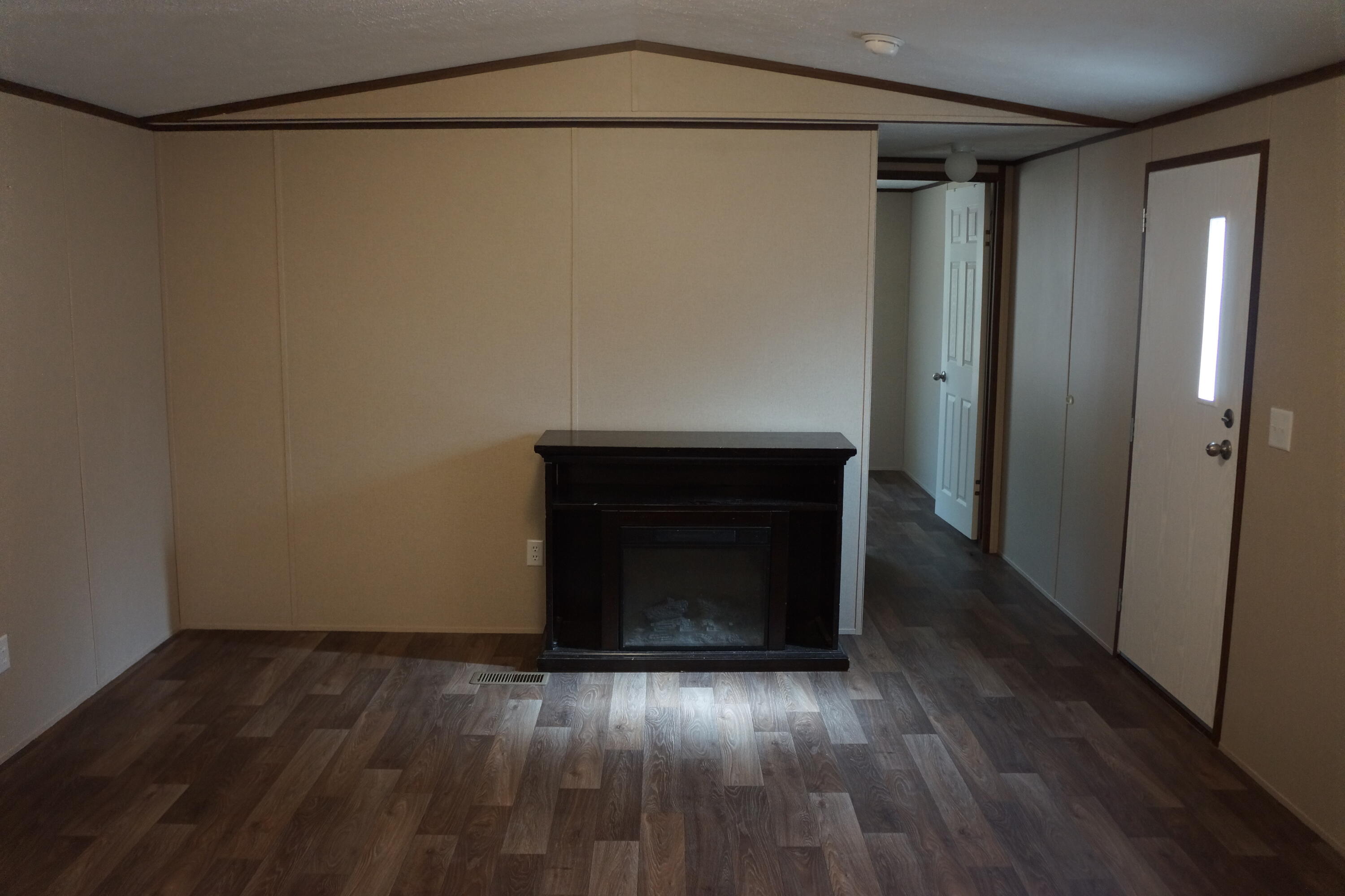 3031 Sandy Lane Crestview, FL 32536 - Photo 14 of 27 a view of empty room with wooden floor and fireplace