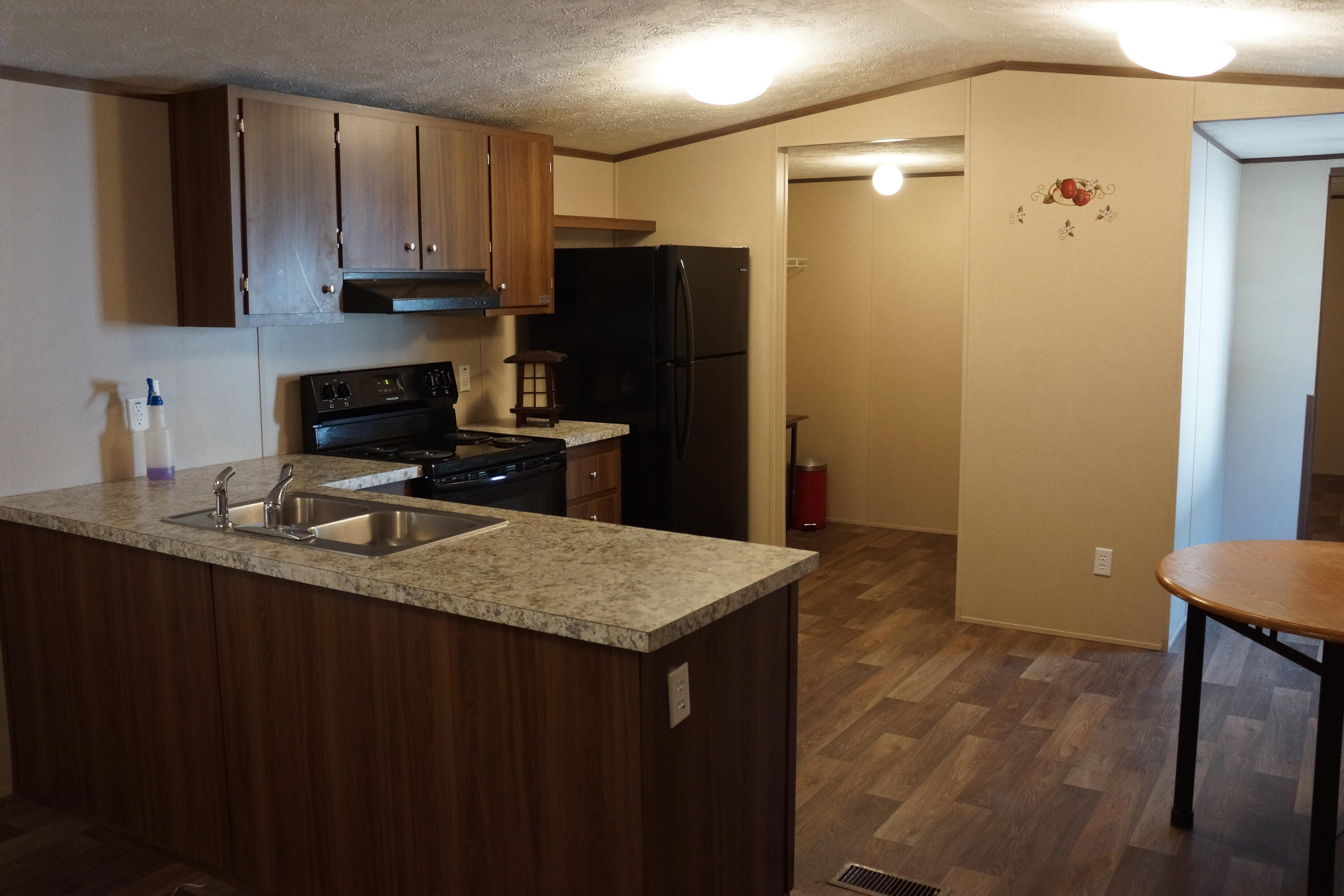3031 Sandy Lane Crestview, FL 32536 - Photo 15 of 27 a kitchen with a sink a refrigerator and cabinets