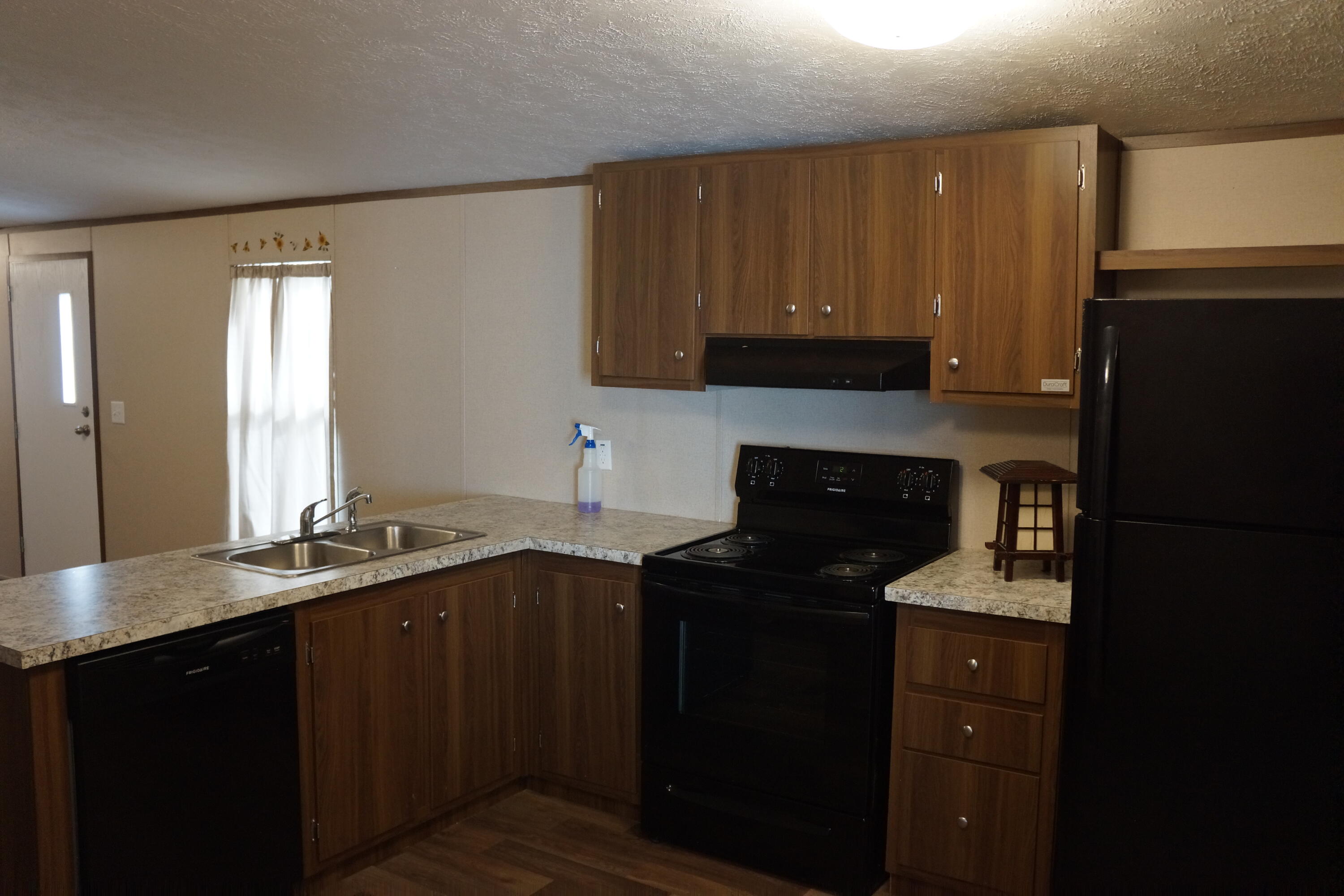3031 Sandy Lane Crestview, FL 32536 - Photo 16 of 27 a kitchen with a sink a stove and cabinets