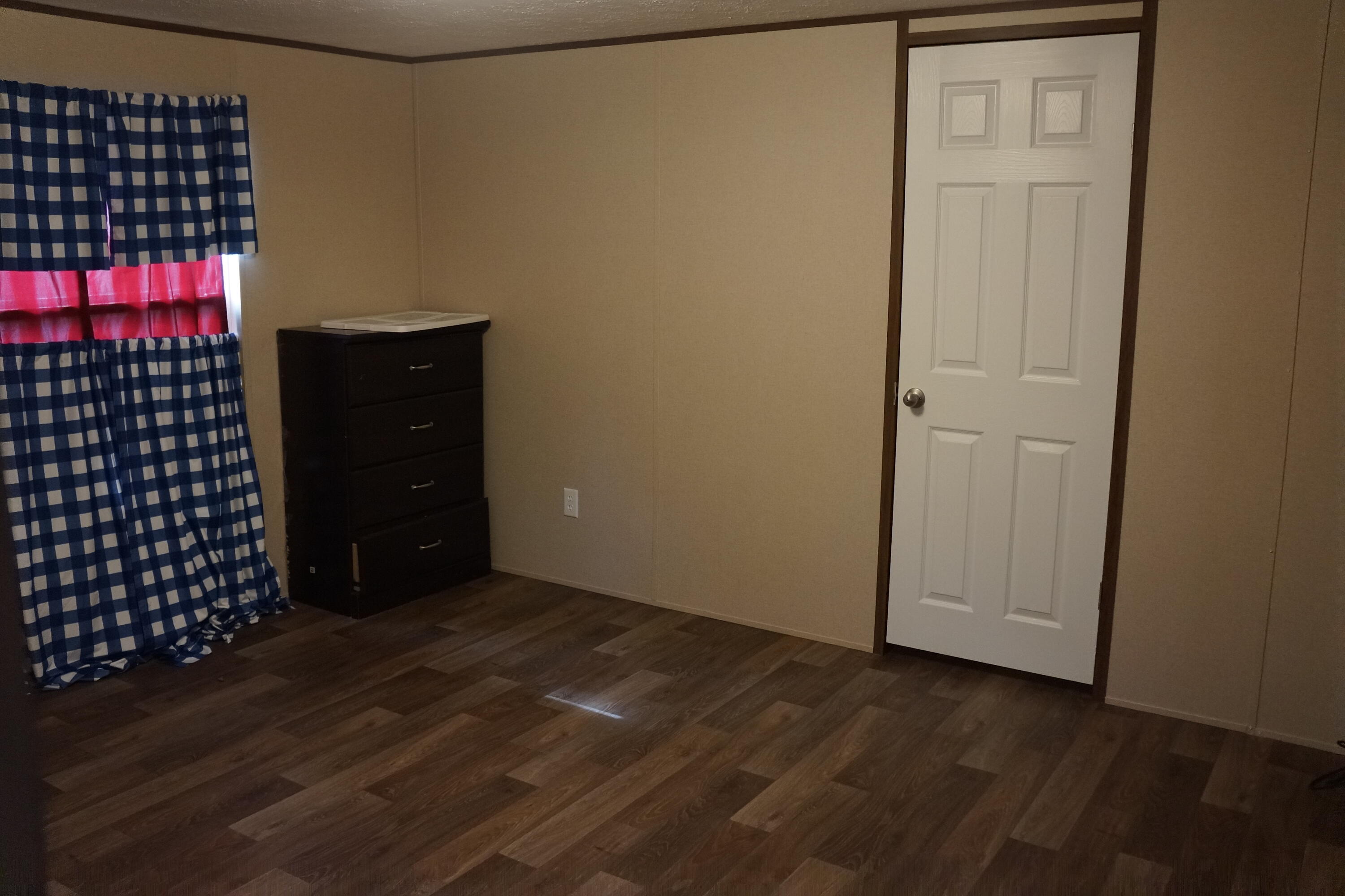 3031 Sandy Lane Crestview, FL 32536 - Photo 18 of 27 an empty room with wooden floor
