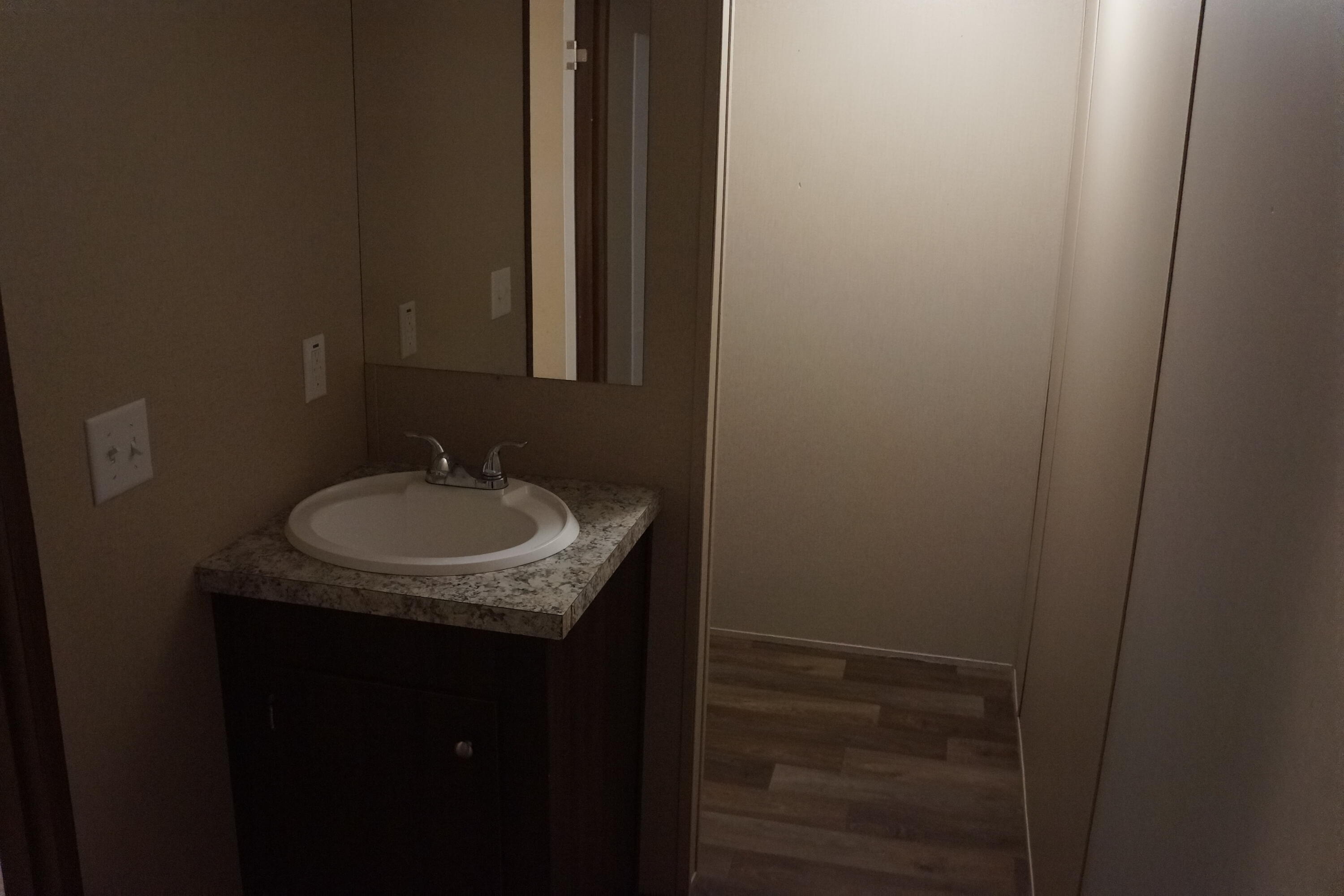 3031 Sandy Lane Crestview, FL 32536 - Photo 19 of 27 a bathroom with a sink and a mirror