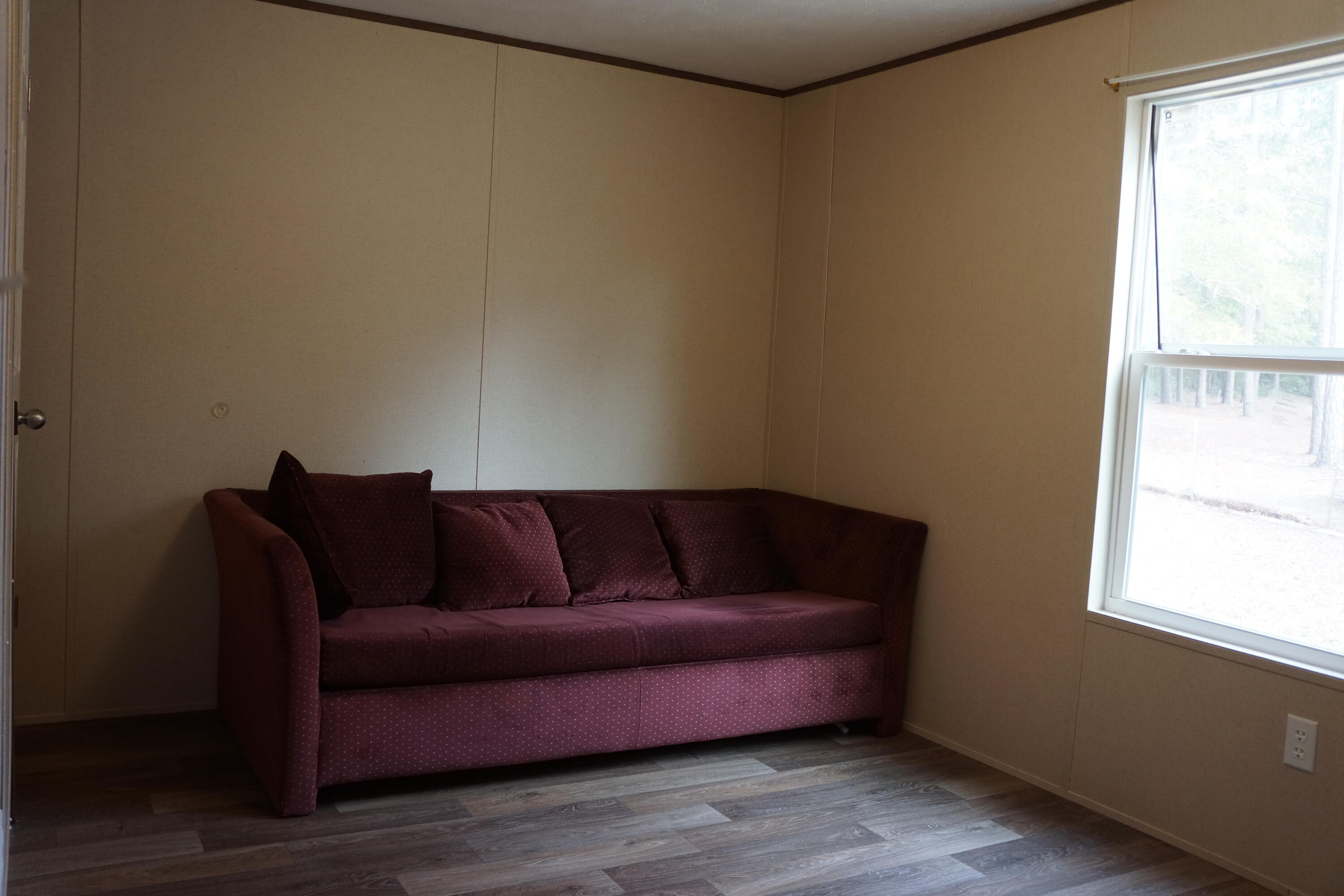 3031 Sandy Lane Crestview, FL 32536 - Photo 20 of 27 a living room with a couch and a window