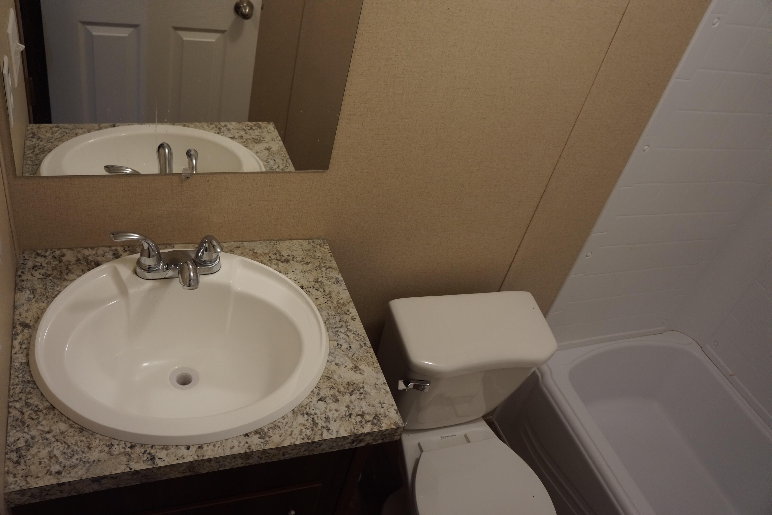 3031 Sandy Lane Crestview, FL 32536 - Photo 21 of 27 a bathroom with a sink and a toilet