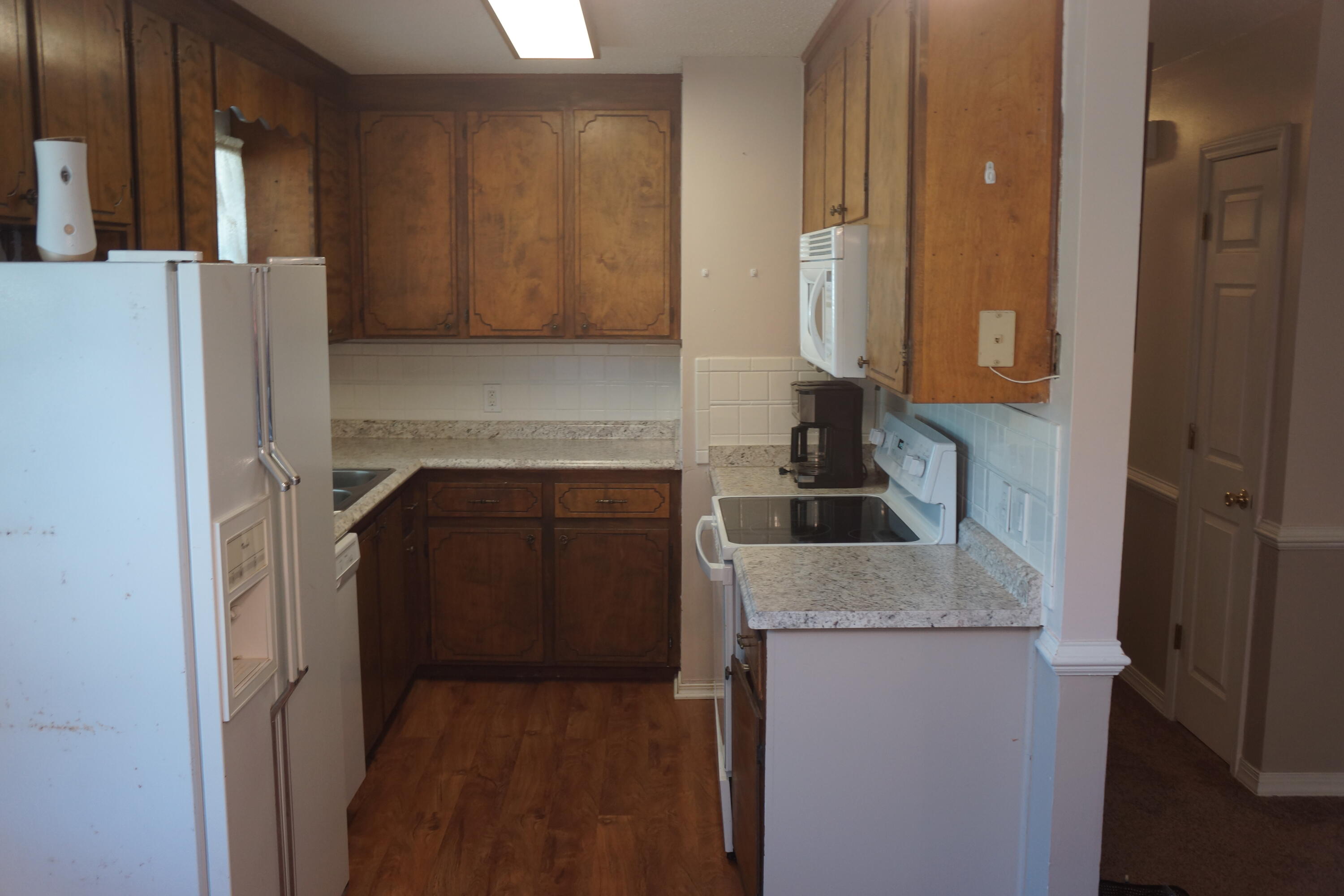 3031 Sandy Lane Crestview, FL 32536 - Photo 4 of 27 a kitchen with a refrigerator sink and stove