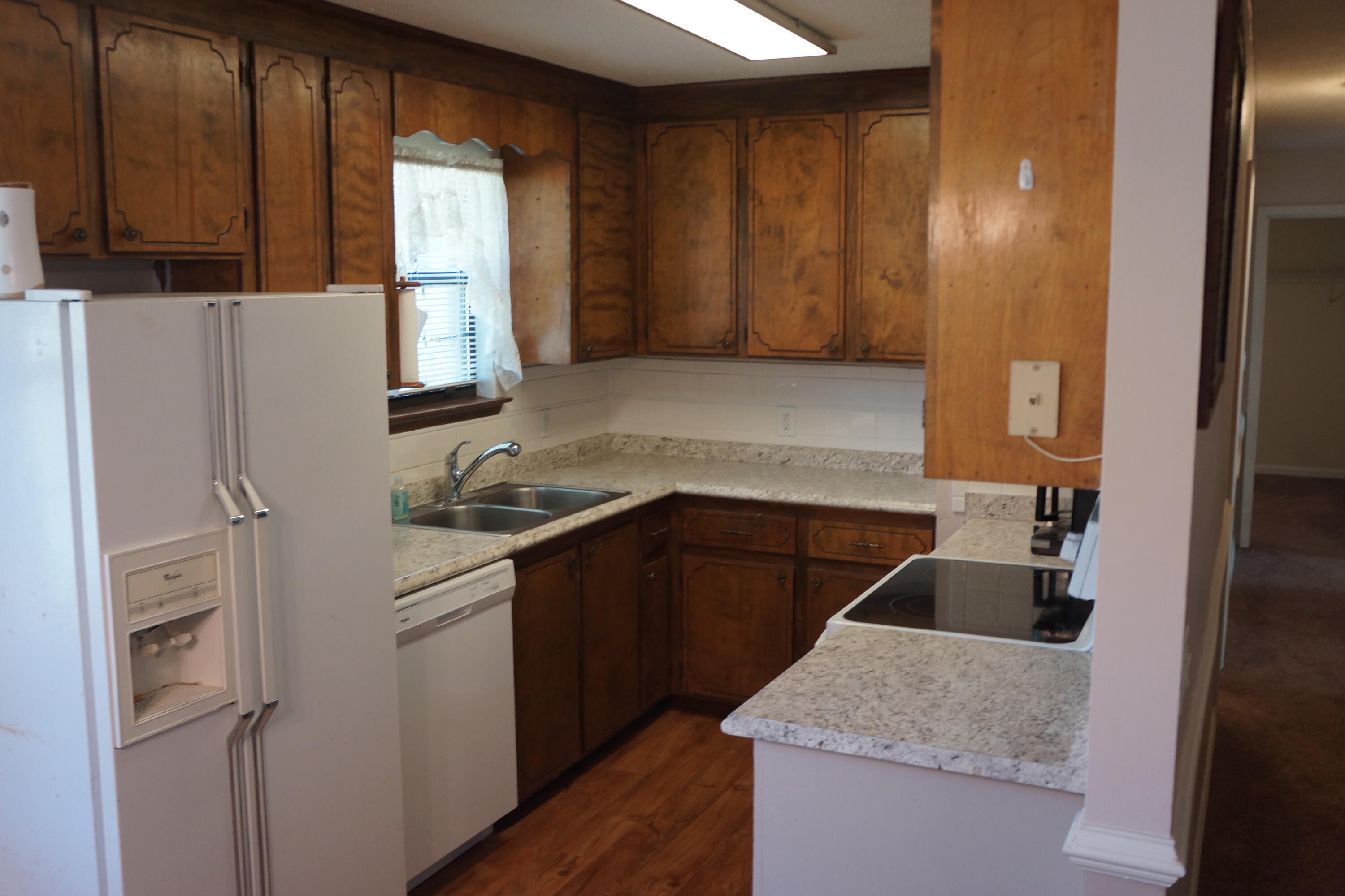 3031 Sandy Lane Crestview, FL 32536 - Photo 5 of 27 a kitchen with a refrigerator stove and sink