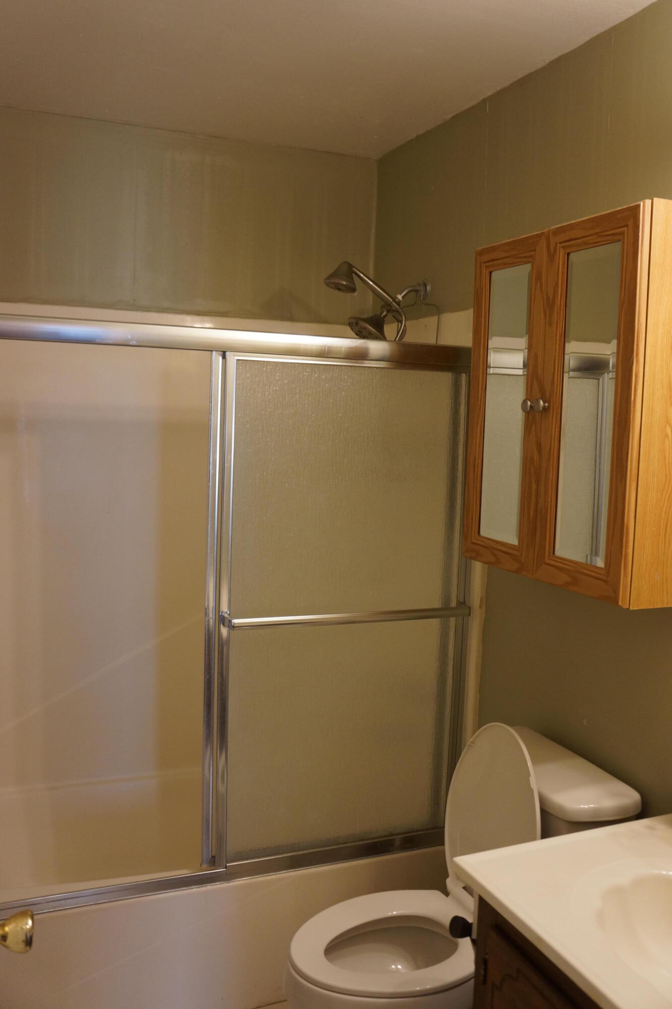 3031 Sandy Lane Crestview, FL 32536 - Photo 7 of 27 a bathroom with a sink a toilet a shower and a mirror