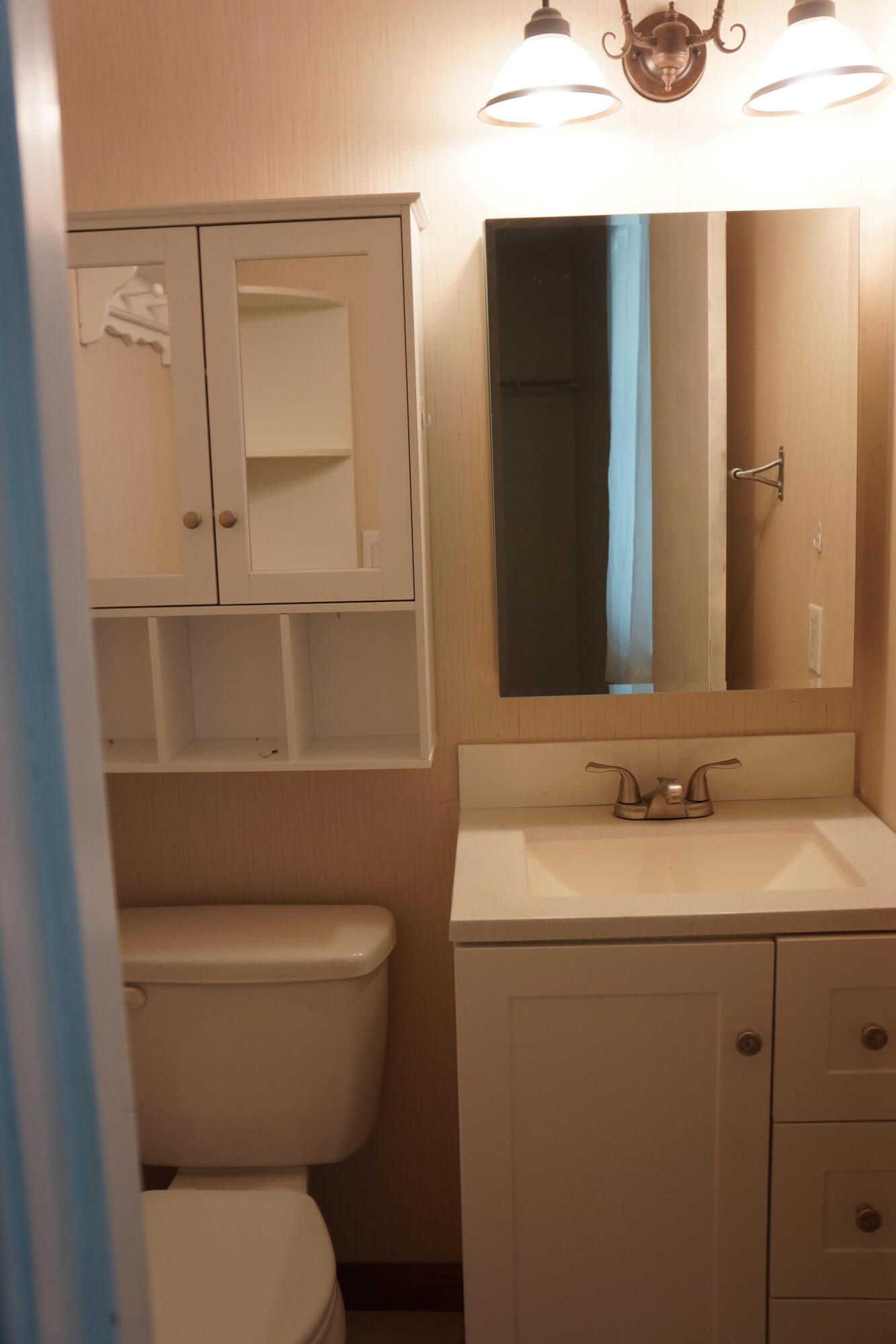 3031 Sandy Lane Crestview, FL 32536 - Photo 9 of 27 a bathroom with a toilet sink and mirror