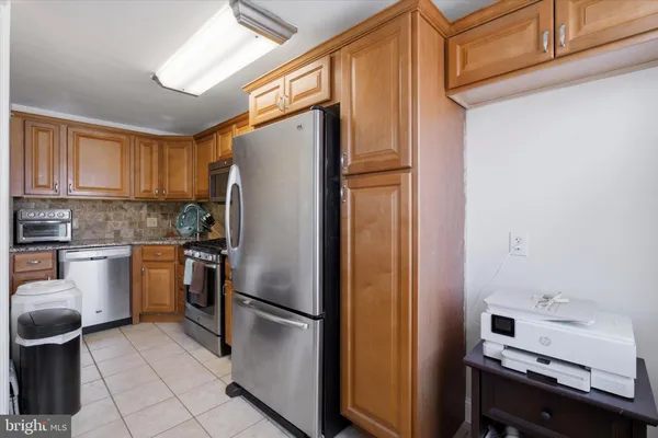 a kitchen with a refrigerator and a stove
