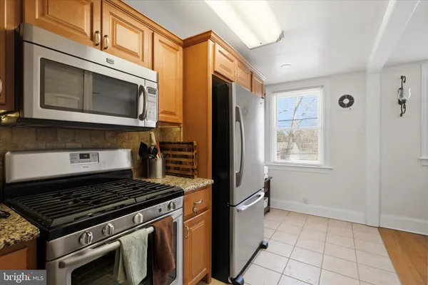 a stove top oven sitting inside of a kitchen