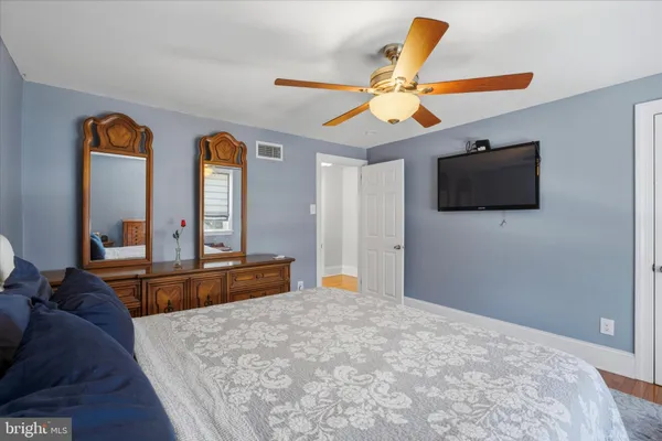 a view of empty room with wooden floor and fireplace