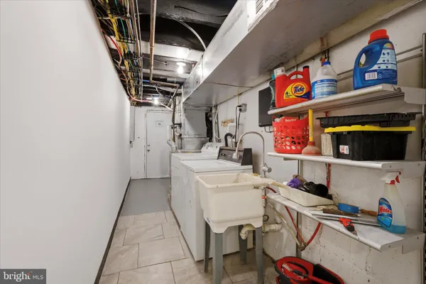 a front view of a house with a yard and tree s