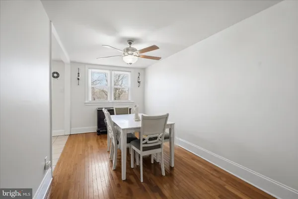 a view of a dining room with furniture a chandelier and wooden floor