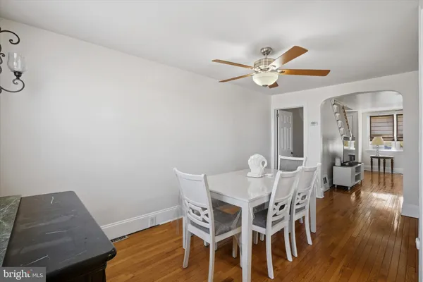 a dining room with furniture and wooden floor