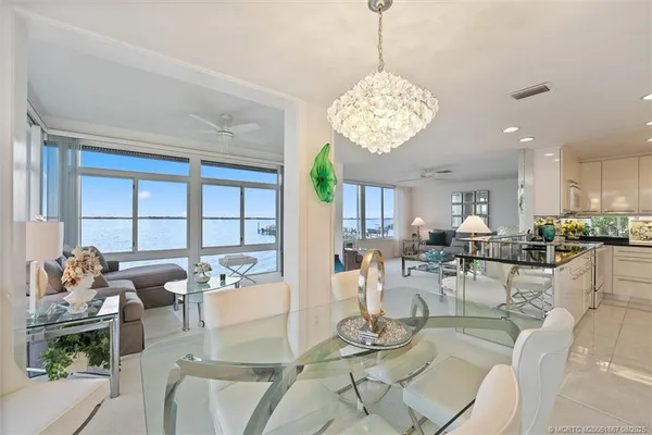 a living room with lots of furniture and a chandelier
