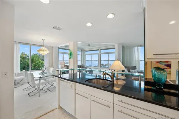 a kitchen with sink and view living room
