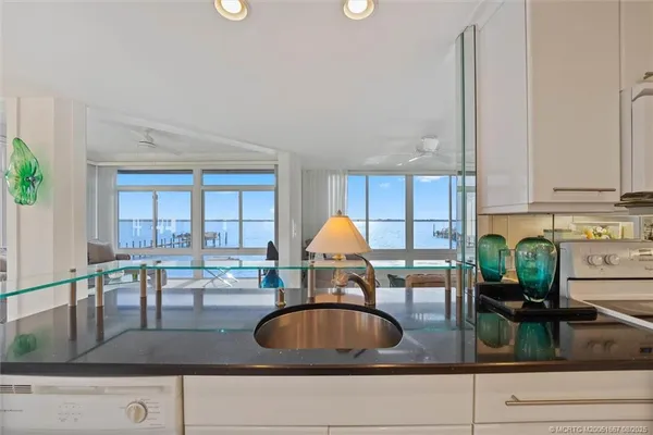 a kitchen with granite countertop a stove a sink and a granite counter tops
