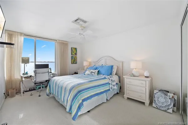 a bedroom with a bed and a chandelier