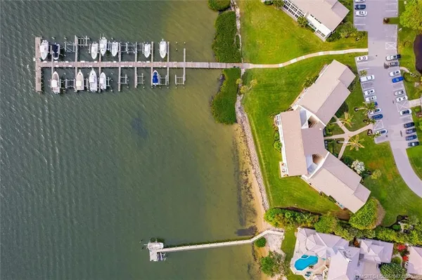 an aerial view of residential houses with an outdoor space and seating