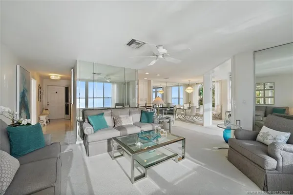 a living room with furniture and view of kitchen
