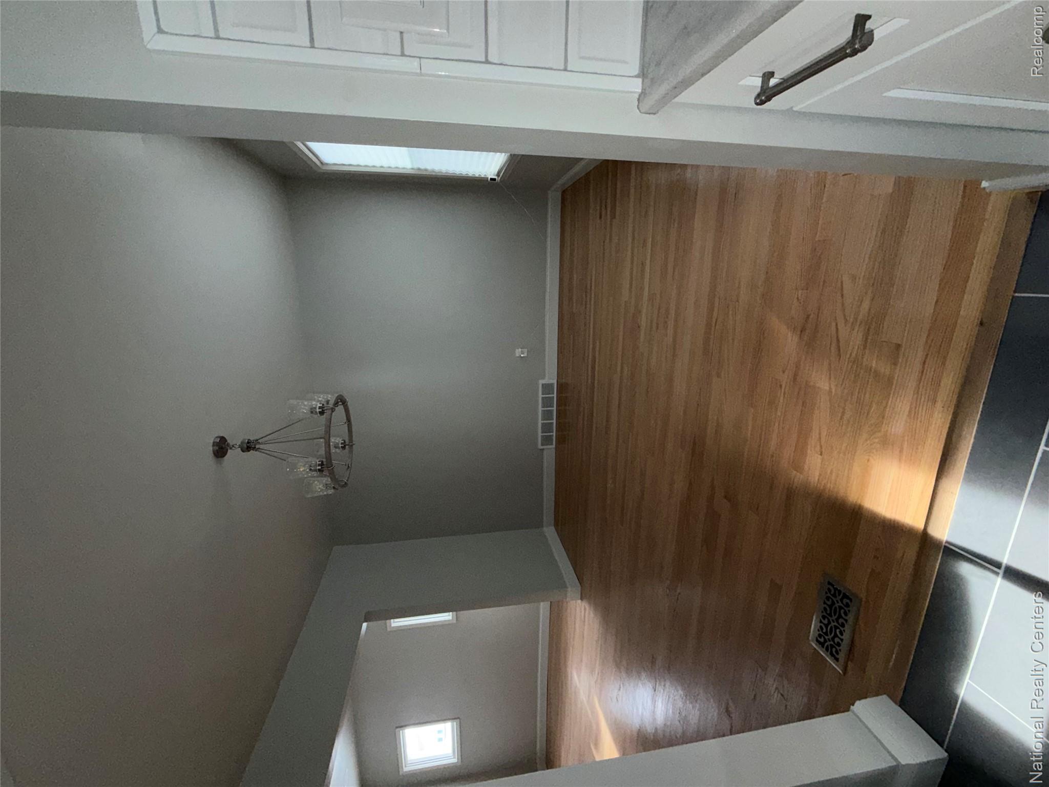 16522 Inverness Street Detroit, MI 48221 - Photo 10 of 62 Unfurnished dining area featuring plenty of natural light, tile patterned flooring, and a chandelier