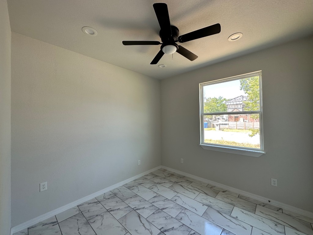 501 Maple Street Taylor, TX 76574 - Photo 11 of 18 wooden floor in an empty room with a window
