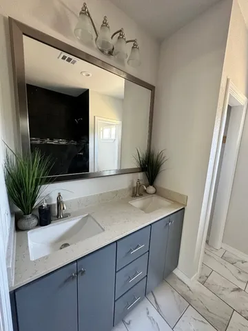 a bathroom with a sink a vanity and a mirror