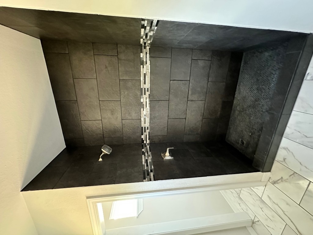 501 Maple Street Taylor, TX 76574 - Photo 15 of 18 a bathroom with a glass door shower