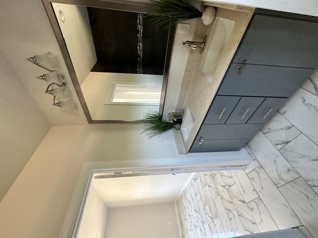 501 Maple Street Taylor, TX 76574 - Photo 16 of 18 a bathroom with a sink and a mirror