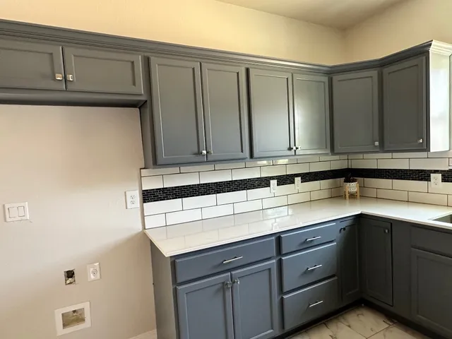 a kitchen with a sink and cabinets