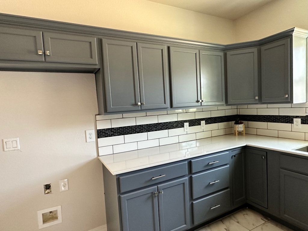 501 Maple Street Taylor, TX 76574 - Photo 6 of 18 a kitchen with a sink and cabinets