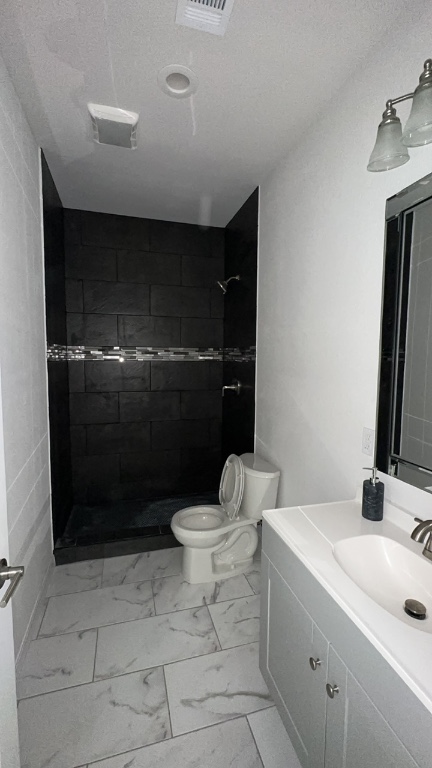 501 Maple Street Taylor, TX 76574 - Photo 9 of 18 a bathroom with a sink a toilet and shower