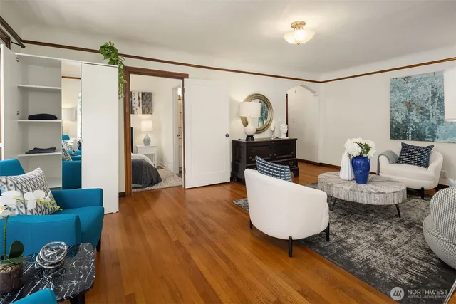 a living room with furniture and wooden floor