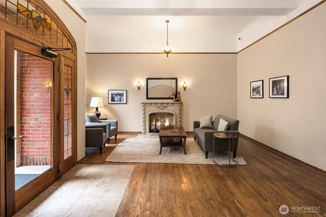 a living room with furniture wooden floor and a fireplace