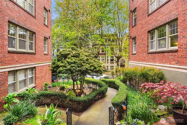 a bunch of flowers in front of brick building