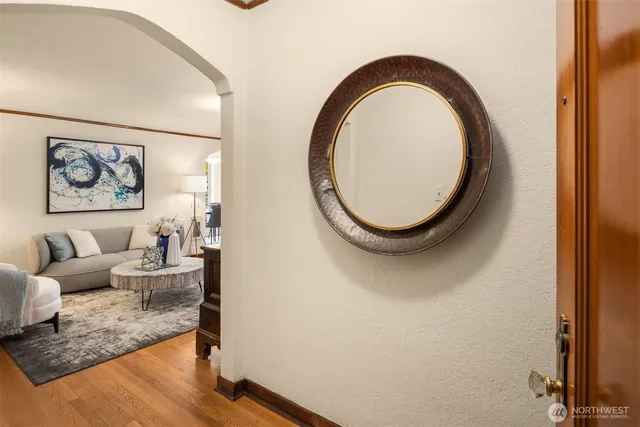 a living room with furniture a mirror and a window