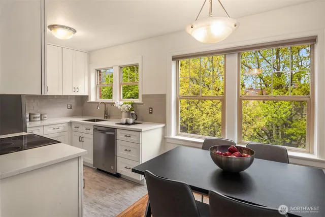 a kitchen with a sink and white cabinets