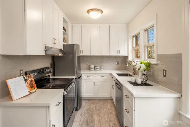 a kitchen with a sink stove and cabinets