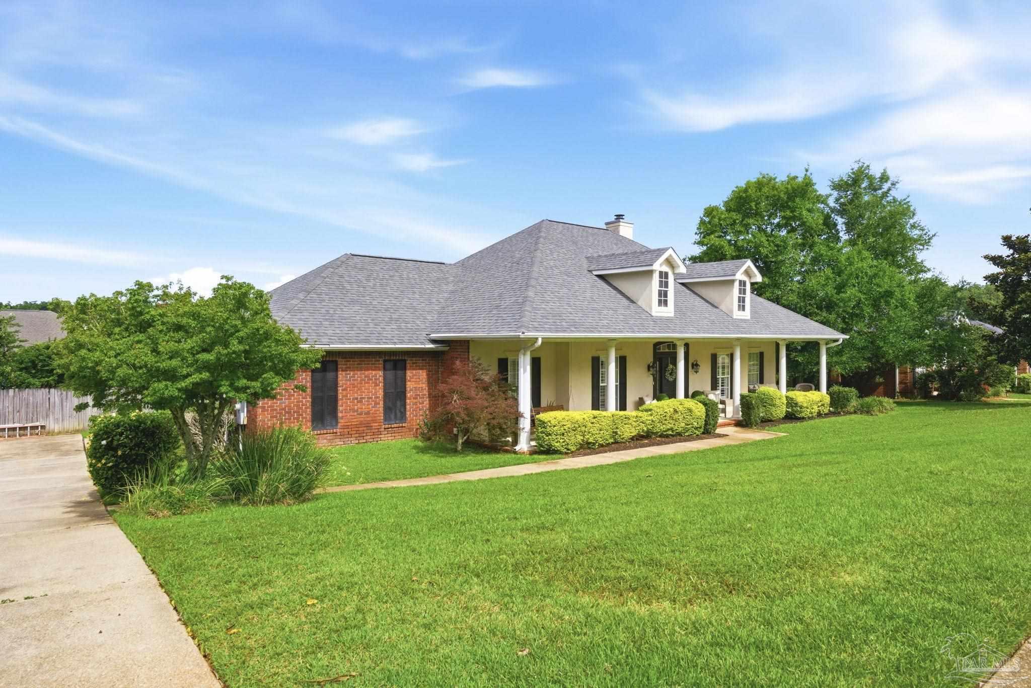 5931 Otter Point Road Pensacola, FL 32504 - Photo 3 of 67 a front view of a house with a garden
