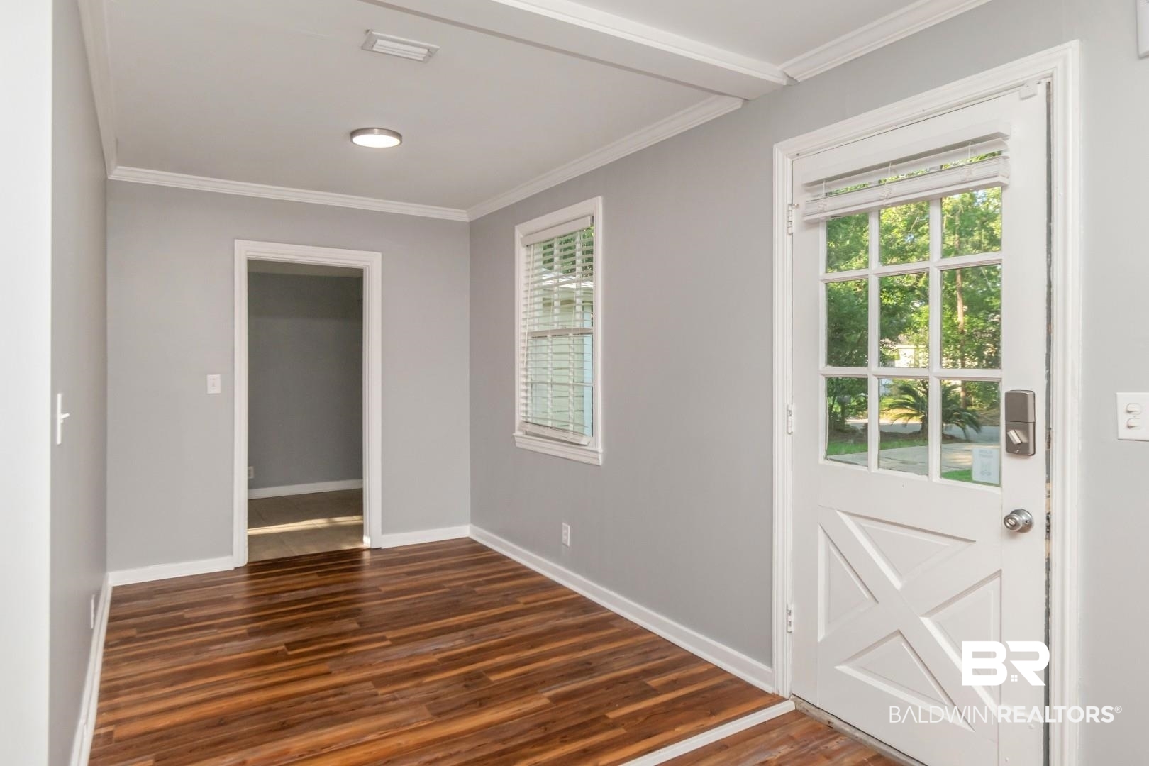 263 Border Drive East Mobile, AL 36608 - Photo 4 of 27 Wood-finish flooring throughout, complemented by light gray wall paint and white trim
